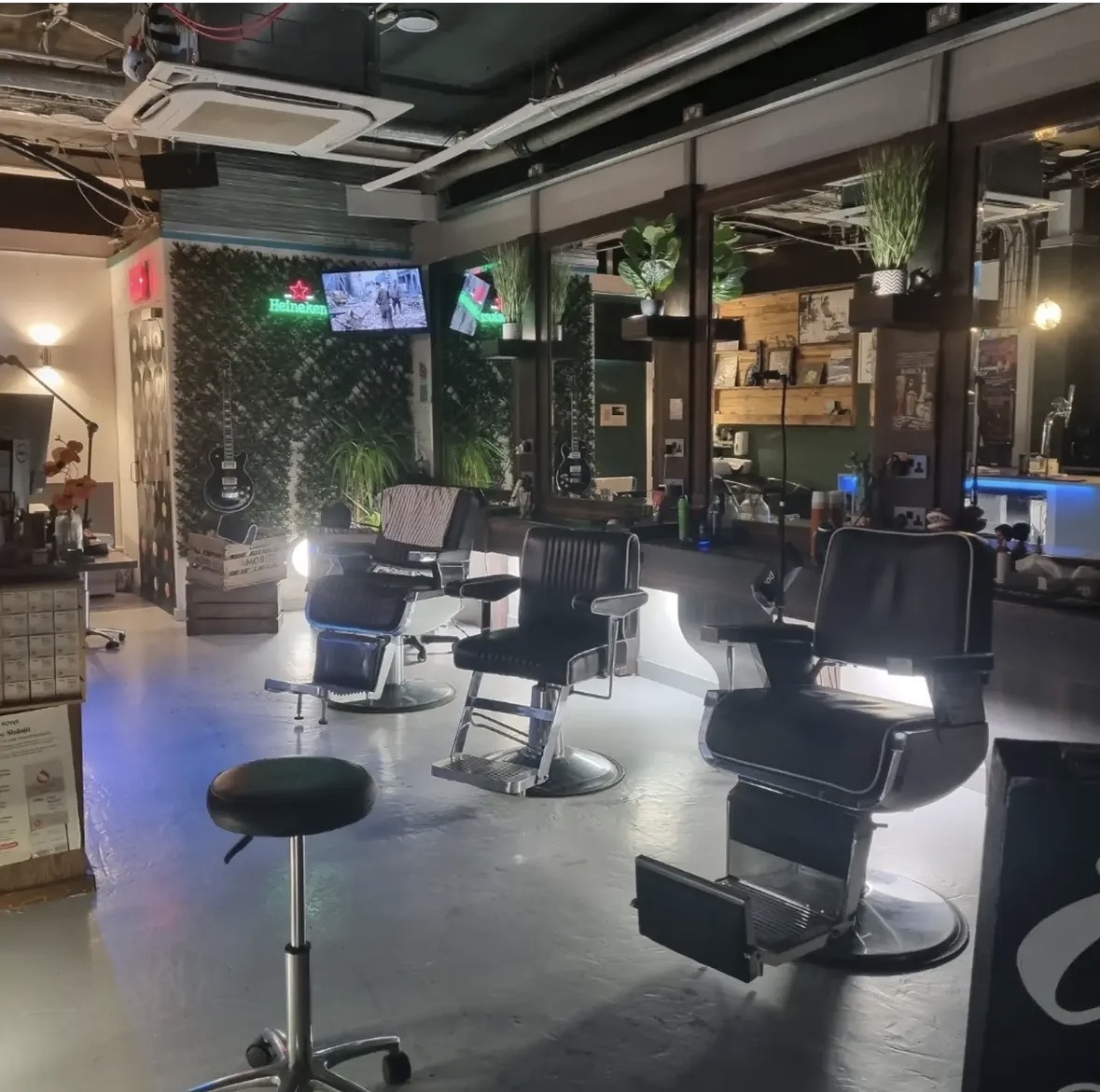 Inside EST22 Barbers with barber chairs, mirrors and plants
